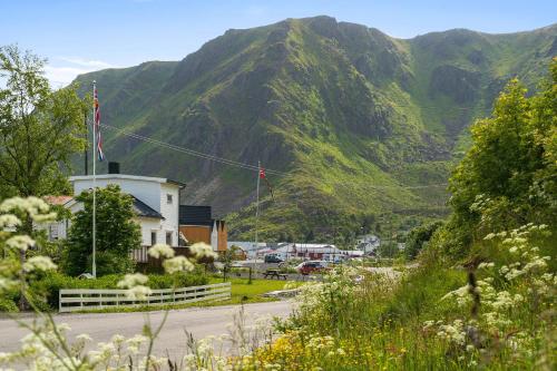 a small town in front of a mountain at KB Reinholmen house in Ballstad