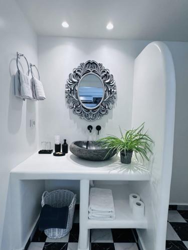 a bathroom with a sink and a mirror at Arlene Suites in Mesaria