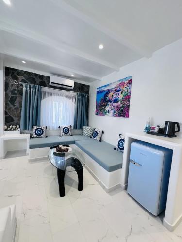a living room with a blue couch and a table at Arlene Suites in Mesaria