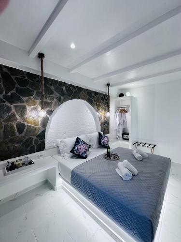 a bedroom with a large bed with two towels on it at Arlene Suites in Mesaria