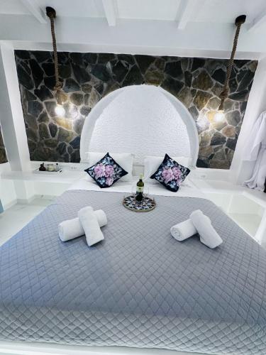 a bedroom with a large bed with two pillows at Arlene Suites in Mesaria