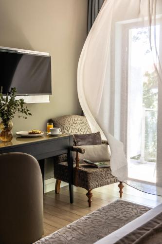 a room with a table and a chair and a window at The Y Hotel in Athens