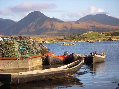 three boats filled with nets on a body of water at Dooneen House in Clifden