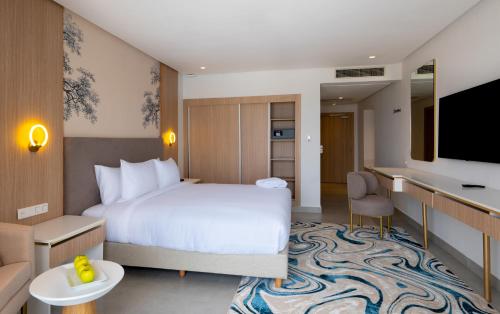 a hotel room with a bed and a tv at Pickalbatros Palais Des Roses - Agadir - All Inclusive in Agadir
