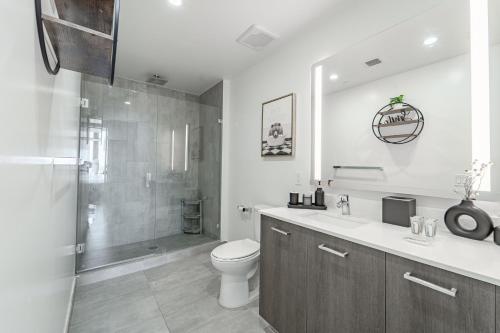 a bathroom with a toilet and a sink and a shower at TR Miami 2 Bedroom, 1 Bedroom, and Studio Condos with Balconies in Miami