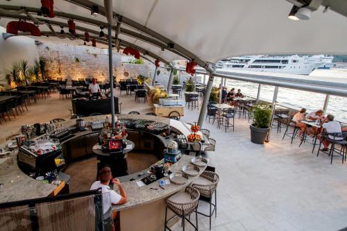 a restaurant on a cruise ship with people sitting at tables at Marshal Hotel Heritage in Vis