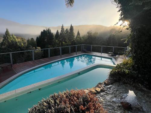 a large swimming pool with mountains in the background at RIVERLEA RETREAT MUDGEE - Private, Outdoor Bath, Pool, Tranquility in Apple Tree Flat