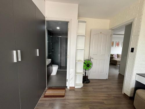 a room with a bathroom with a toilet and a hallway at Modern Garden Apt by Dragon bridge in Da Nang