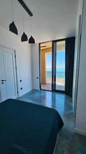 a bedroom with a bed and a view of the ocean at Bristol in Kvariati