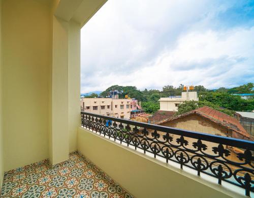 a balcony with a view of a city at Olive Hotel Chikkamagalur by Embassy Group in Jāmb
