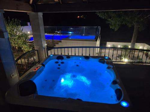 a swimming pool in the middle of a yard at night at Villa Stipanovi Dvori in Vodenjak
