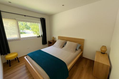 een slaapkamer met een groot bed en een raam bij La Rive in Le Bourg-dʼOisans