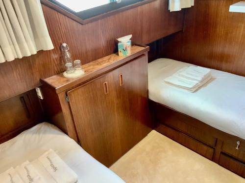 a small room with two beds in a boat at Stunning Motor Yacht in Corfu in Gouvia