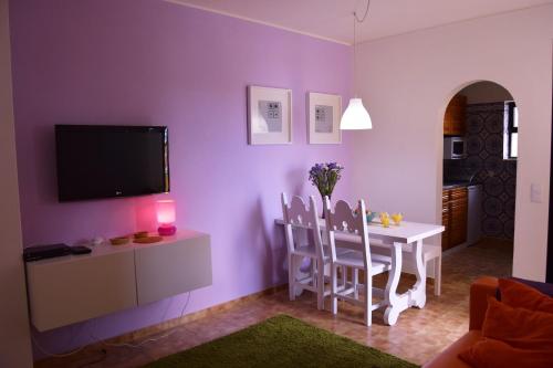 a living room with a table and a purple wall at Aurora Houses in Lagos