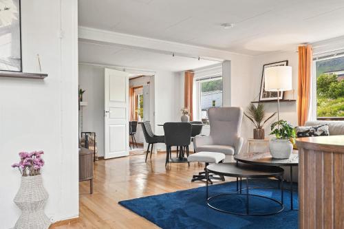 a living room and dining room with a table and chairs at KB Reinholmen house in Ballstad