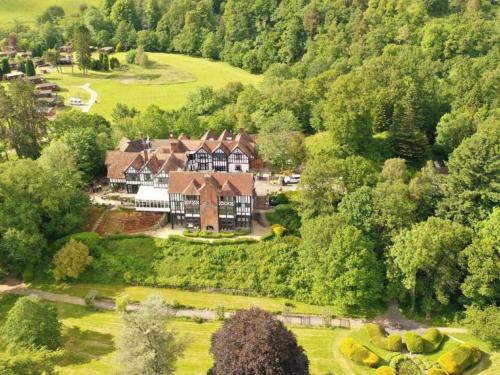 an aerial view of a large house in the forest at Caer Beris Hotel in Builth Wells