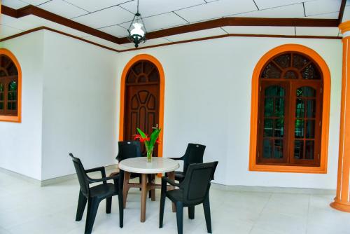 a dining room with a table and chairs at Osha Villa in Aluthgama