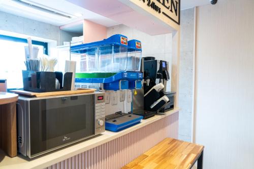 a shelf in a kitchen with a fish tank at Hotel Ippda Wonju in Wonju