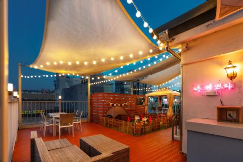 a patio with lights and a table on a balcony at Hotel Ippda Wonju in Wonju