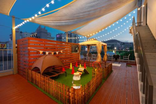 a patio with a tent and a table on a deck at Hotel Ippda Wonju in Wonju