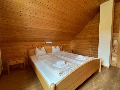 a bedroom with a bed in a wooden room at Chalets am Feuerkogel - LANDLUFT in Ebensee