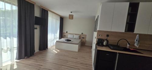 a kitchen with white cabinets and a counter top at Black Sea Pearl in Krapets