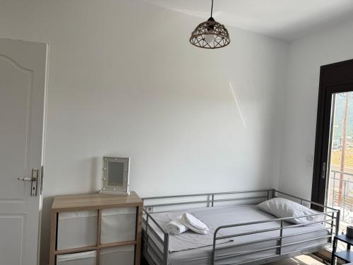 a white bedroom with a bed and a lamp at Welcoming 3 Bedroom Home in Perdika, Thesprotias in Perdika