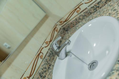 a white toilet in a bathroom with a sink at Apartamentos Turisticos Las Yucas in Torre del Mar