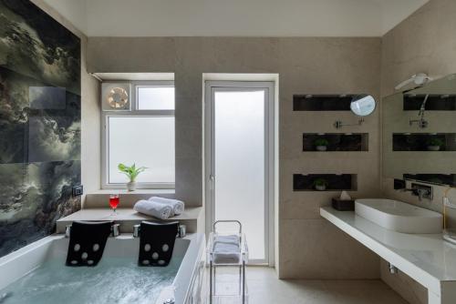 a bathroom with a bath tub and a table and chairs at Sitara Palace and Resort in Bhopal