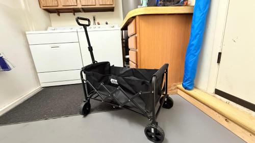 a black shopping cart in a kitchen next to a window at The Wavestay I 4 min walk to Beach in Satellite Beach