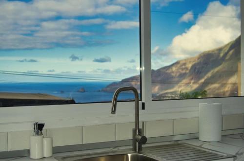 a kitchen sink and a window with a mountain view at La Ladera in Frontera