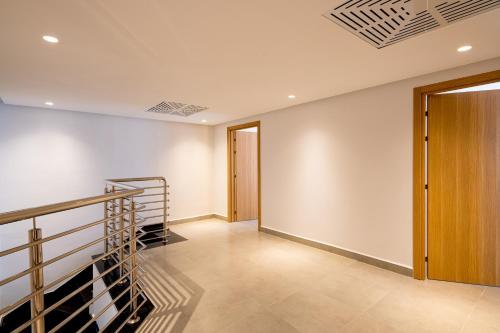 an empty hallway with a staircase and a door at Pickalbatros Palais Des Roses - Agadir - All Inclusive in Agadir