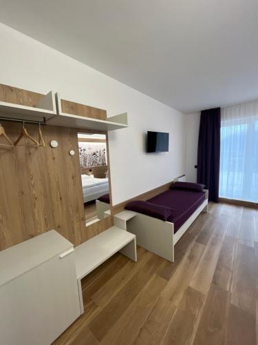 a bedroom with a bed with a purple mattress at Agritur Gasadòr in Trento
