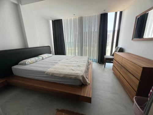 a bedroom with a bed and a large window at Luxury Seafront Duplex Villa With Pool9 in Cesme