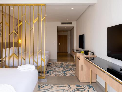 a hotel room with a tub and a television at Pickalbatros Palais Des Roses - Agadir - All Inclusive in Agadir