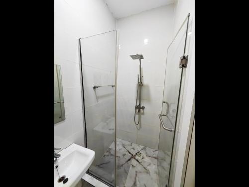 a bathroom with a glass shower and a sink at AB Luxury 2 bedroom Apartment with 24hr Electricity, Wifi, Fully Equipped Kitchen in Lagos