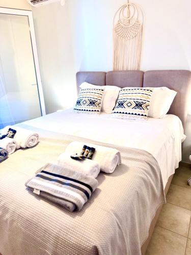 a bedroom with two beds with towels on them at Selini Seaview Villa in Kissamos