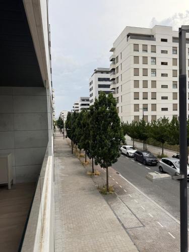 a sidewalk with trees in front of a building at Soto Deluxe by Clabao in Pamplona