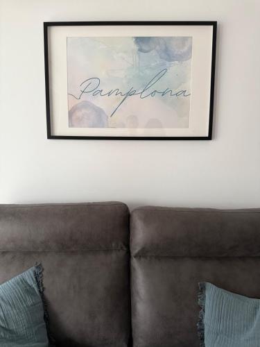a picture hanging on a wall above a couch at Soto Deluxe by Clabao in Pamplona