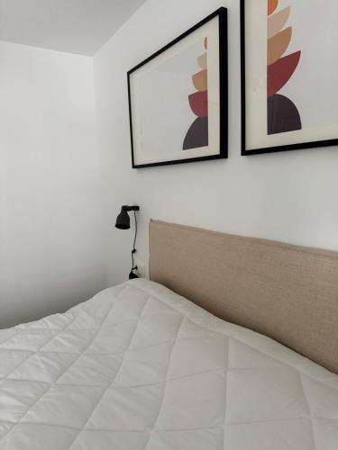 a bedroom with two pictures on the wall and a bed at Soto Deluxe by Clabao in Pamplona