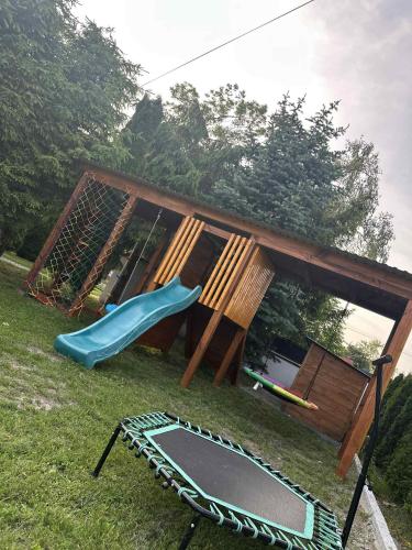 a playground with a slide and a trampoline at LUX HOUSE Roztocze 1 in Krasnobród