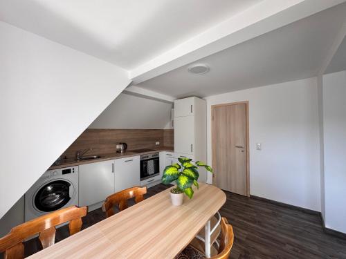 a kitchen and dining room with a wooden table at Ferienwohnung Hubertus in Blankenstein