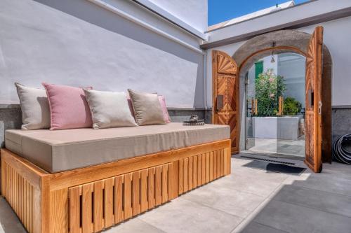 a bed with pillows on it in a room at Casita Moritz - Luxury - 1 min to the Beach By Lanzarote Vacation Homes in Costa Teguise