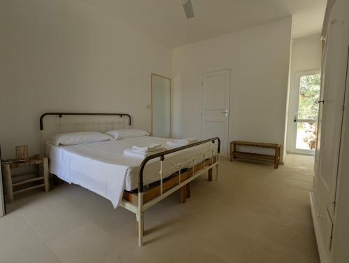 a bedroom with a bed in a white room at Il Monile in Otranto