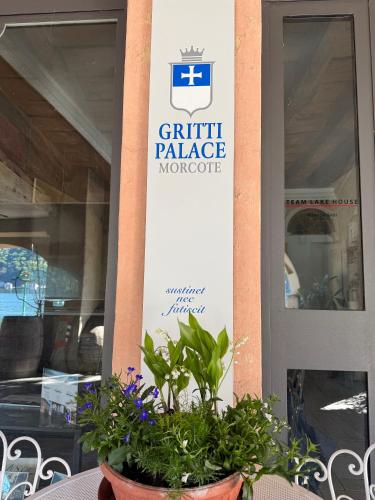 a sign on the side of a building with a plant at Gritti Palace Morcote - Vaniglia in Morcote