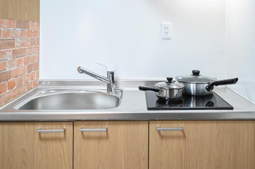 Kuchyň nebo kuchyňský kout v ubytování 大阪梅田淀川花民宿101套房