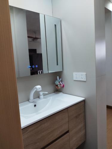 a bathroom with a sink and a mirror at Whale House in Chongqing