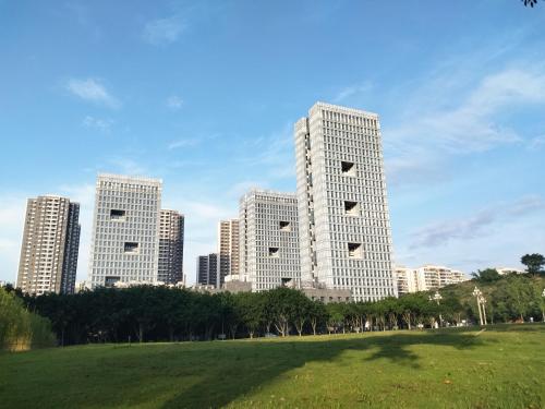 a tall building in front of a city at Whale House in Chongqing