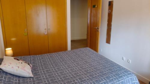 a bedroom with a bed with a pillow on it at Rooms_Heart Apartment in Faro