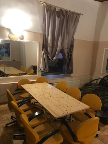 a conference room with a wooden table and chairs at Apartment SKAISTUMS in Jūrmala